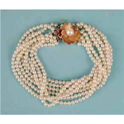 AN EIGHT-STRAND PEARL TORSADE BRACELET WITH 14K YELLOW GOLD AND PEARL CLASP