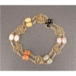 A 14K YELLOW GOLD AND MULTI-COLORED JADE LINK BRACELET
