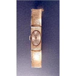 A 14K YELLOW GOLD HINGED BANGLE BRACELET WATCH