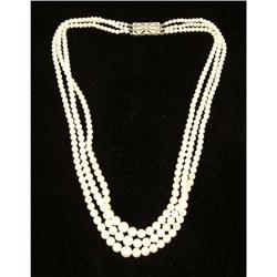 A TRIPLE-STRAND GRADUATED PEARL NECKLACE WITH PLATINUM AND DIAMOND