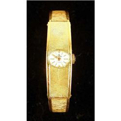 A BUCHERER 18K YELLOW GOLD HINGED BANGLE BRACELET WRISTWATCH