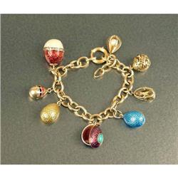 A 14K YELLOW GOLD AND ENAMEL CHARM BRACELET WITH ENAMEL AND GOLD