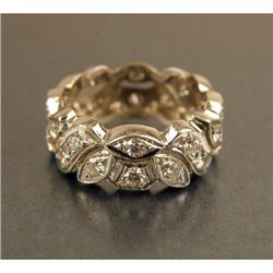 AN 18K WHITE GOLD AND DIAMOND FOLIATE MOTIF BAND