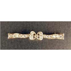 A PLATINUM AND DIAMOND BOW BROOCH