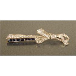 A PLATINUM, DIAMOND AND SAPPHIRE BOW BROOCH