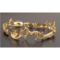 A 14K YELLOW GOLD "COWBOY" MOTIF LINK BRACELET