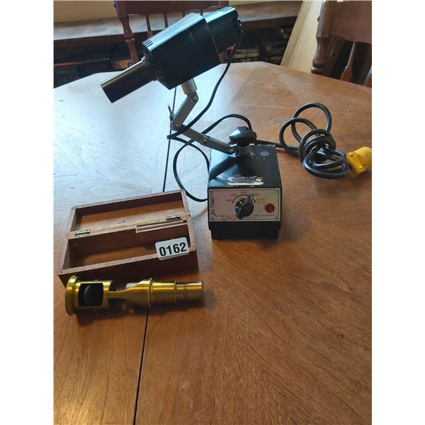 Vintage brass hand-held microscope and light