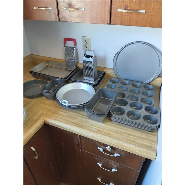 Asst bakeware, muffin tins, loaf tins, pizza pans, pie plates, cake pans and graters