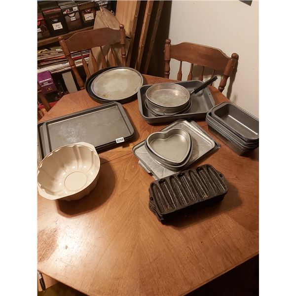Asst bakeware, cookie sheets, cake/loaf pans, cast iron corn moulds for cornbread