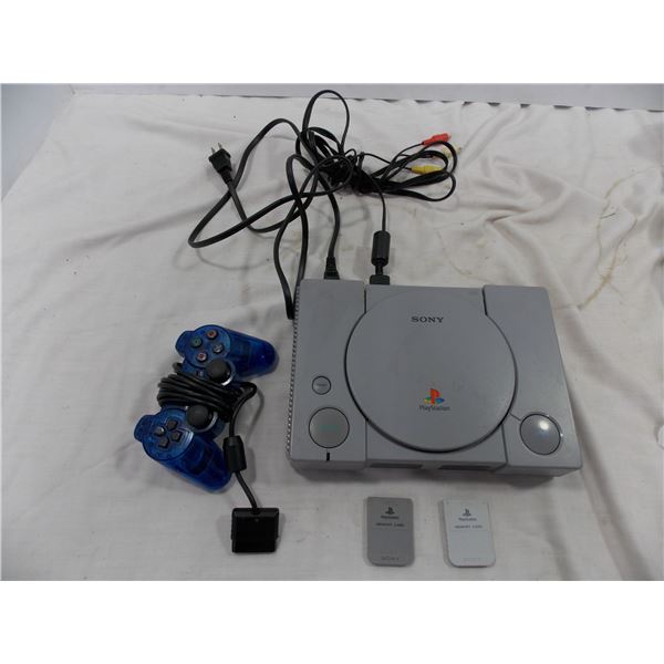 Original Playstation 1 console with 2 memory cards + hookups (powers on - open button sticks down)