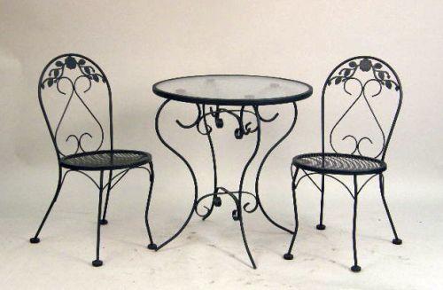 A Modern Wrought Iron Ice Cream Parlor And Glass Topped Table And Chairs