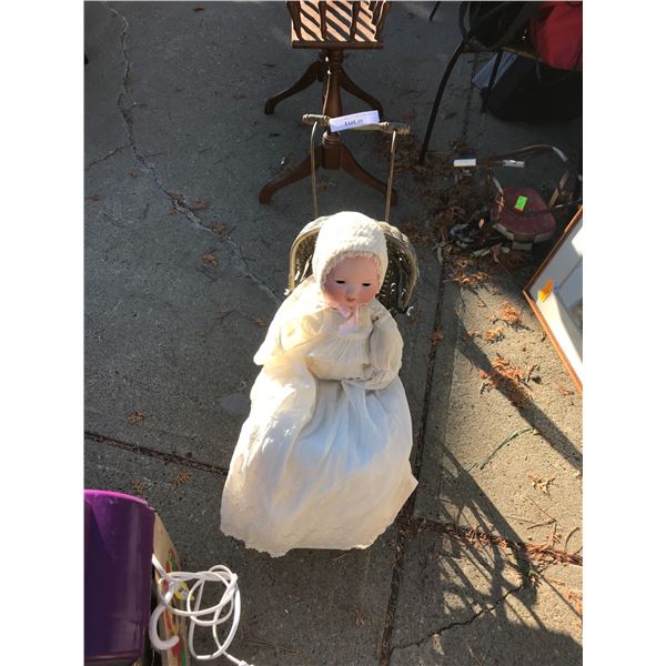 Vintage baby carriage with ceramic doll