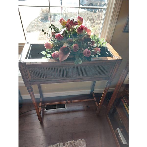 Wooden planter stand with artificial flower arrangement
