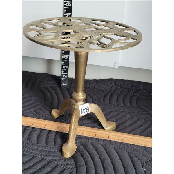 Solid Brass plant stand with ornate geese on table top.