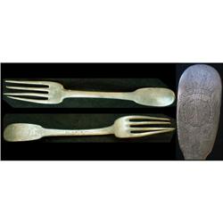 Silver fork bearing family insignia on the up