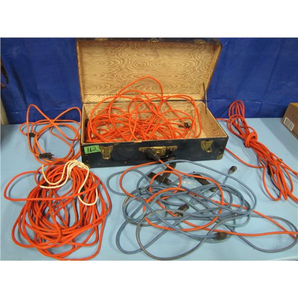 old tin suitcase with assorted extension cords