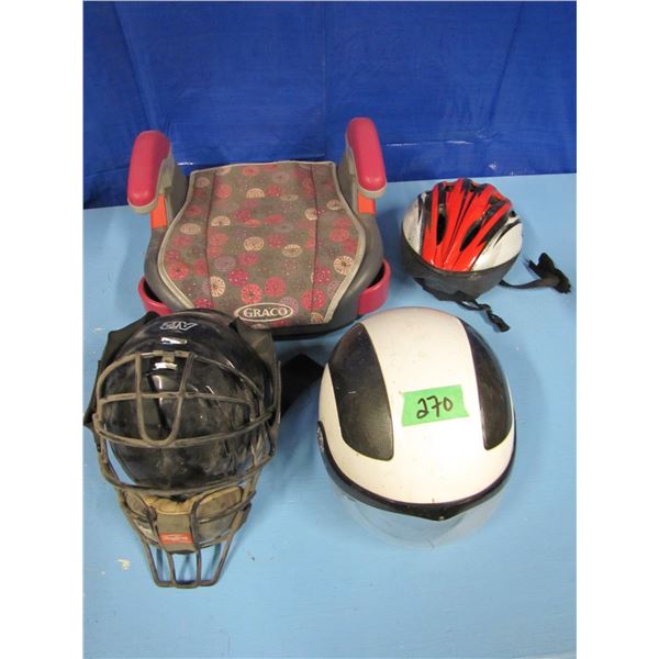 child's booster seat and various helmets