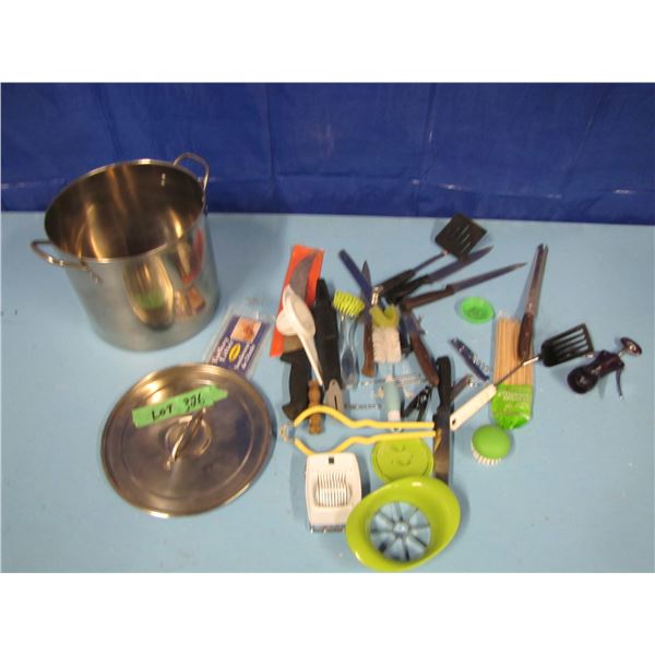 stainless steel pot with assorted knives and kitchen utensils