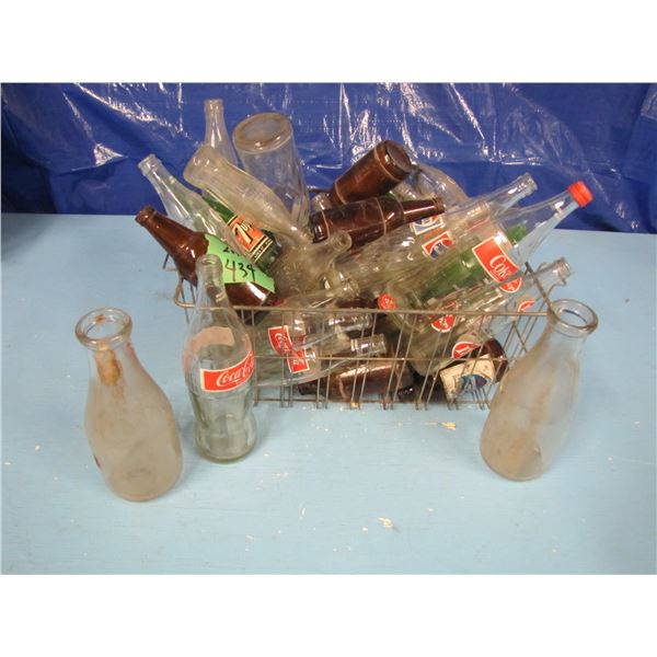 lot of assorted drink bottles, Coke, 7UP, milk bottles etcetera