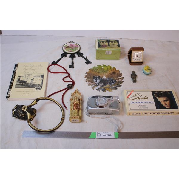 Elvis casettes, brass knocker, travel clock, bolo tie, painted saw blade, etc