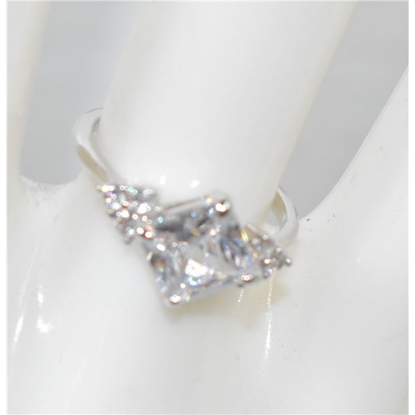 4)  SILVER TONE AND CLEAR CZ RING SIZE 5