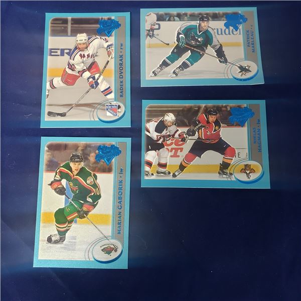 four Serial numbered insert hockey cards