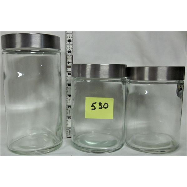 Set of 3 clear glass canisters with silver colored lids