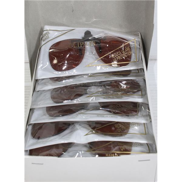 BOX OF AMBER COLOR CLIP-ON SUNGLASSES.