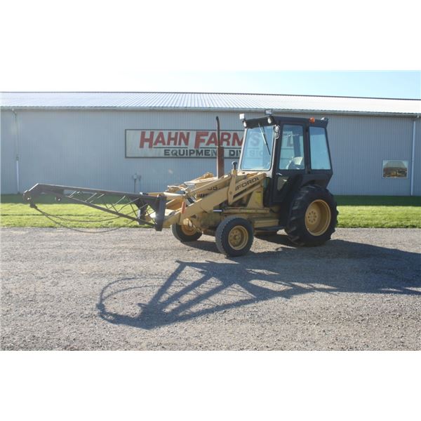 Ford 555 2wd loader tractor, cab, shuttle with loading boom. Hahn Farms yard unit