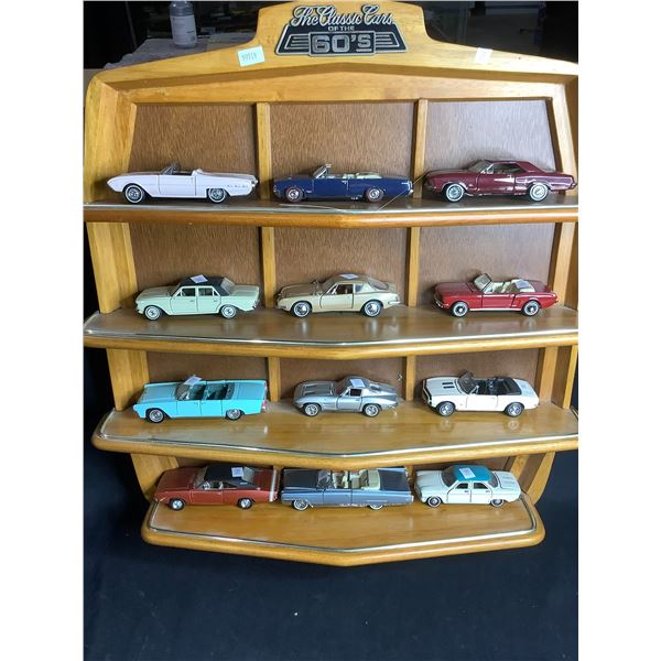FRANKLIN MINT COLLECTION OF 12 CARS "THE CLASSIC CARS OF THE SIXTIES" INCLUDES WALL MOUNT SHELF AND