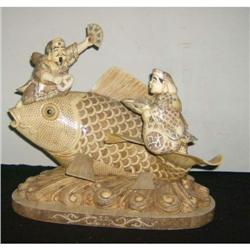 Bone carving Gods of fortion atop fish