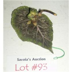 Vienna bronze frog playing instrument atop leaf