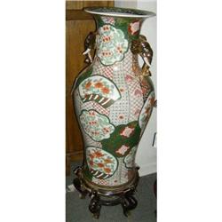 Oriental floor vase on wooden stand with figural elephant handles