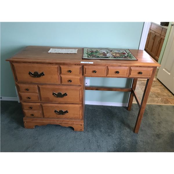 4-drawer wood desk with placemat and doily