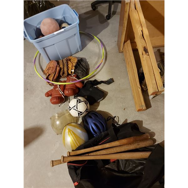 Box of assorted sports equipment including balls, helmets, bats and bag