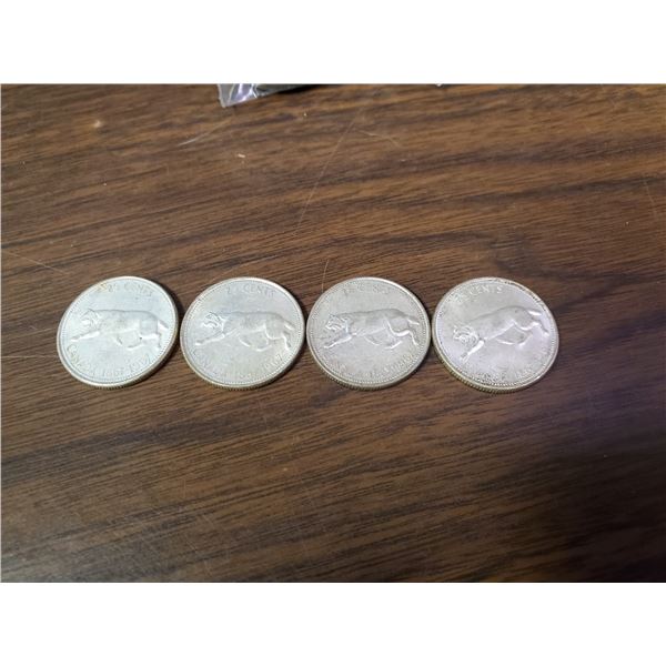 four 1967 silver Canadian quarters