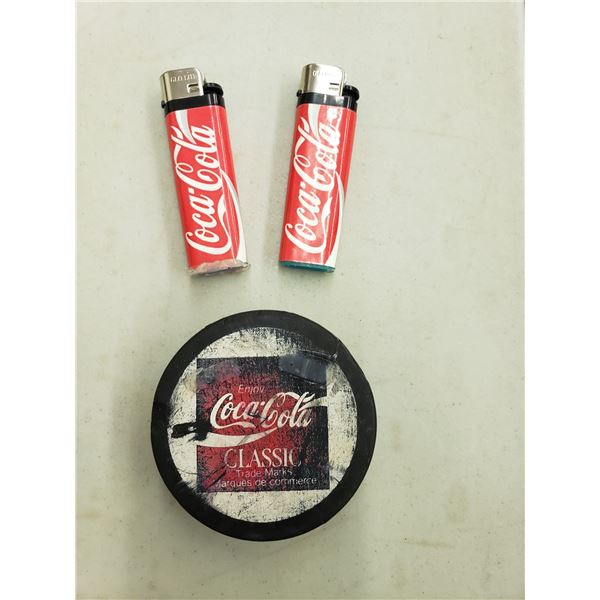 COCA COLA HOCKEY PUCK AND TWO LIGHTS, LIGHTER HAS FALEN OFF PUCK