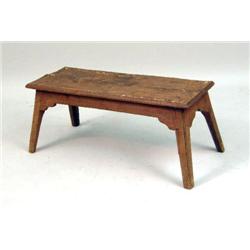 A WOODEN FOOT STOOL