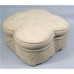 A CLOVER-SHAPED UPHOLSTERED OTTOMAN