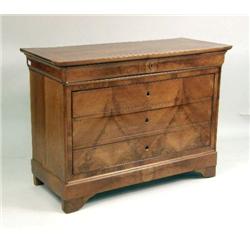 AN EMPIRE WALNUT FOUR-DRAWER COMMODE