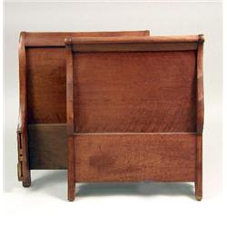 A DIMINUTIVE EMPIRE WALNUT SLEIGH BED