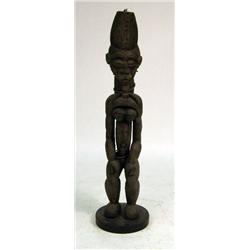 A CARVED AFRICAN SCULPTURE OF A STANDING MAN, PROBABLY IBIBIO, SOUTHEASTERN NIGERIA