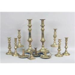 A GROUP OF TWELVE EARLY BRASS CANDLESTICKS