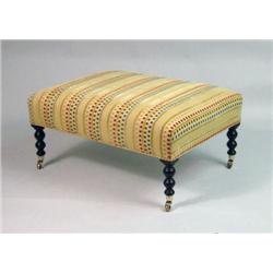 A CONTEMPORARY UPHOLSTERED OTTOMAN