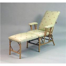 A FAUX BAMBOO UPHOLSTERED LOUNGE CHAIR