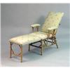 Image 1 : A FAUX BAMBOO UPHOLSTERED LOUNGE CHAIR