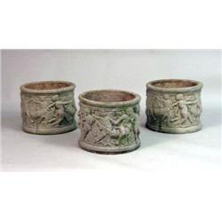 THREE ROUND MOLDED CONCRETE PLANTERS