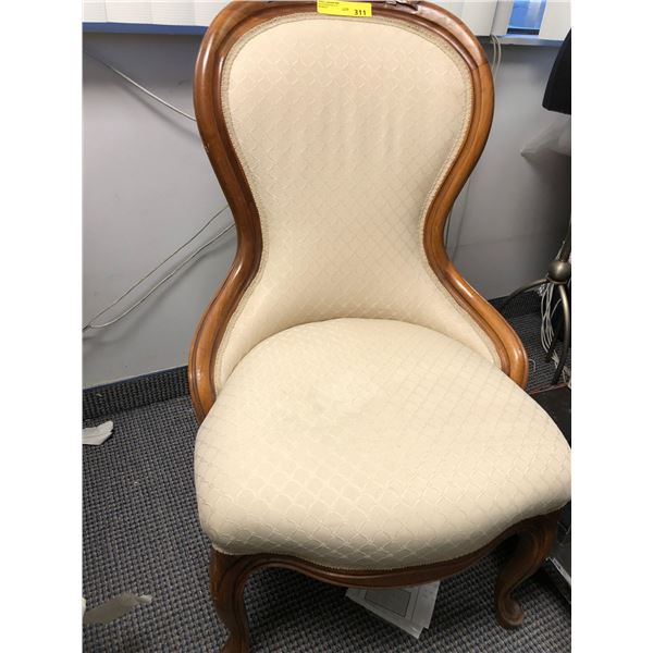 Light beige embossed Fabric Chair with fabric back and carved wood.