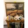 Image 1 : Table with collection of dolls, Ornate Picture of Works at Harvest Time, two metal bins of books and