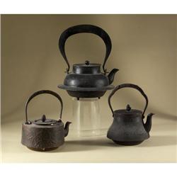 THREE CAST IRON ASIAN TEAPOTS SWING HANDLES